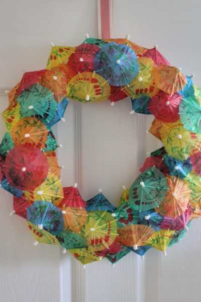 If you need an idea for a summer or spring wreath, you can't go far wrong with this one. It's great for your front door or to welcome your guests at a summer party. This wreath is bursting with colour! With just a box of umbrellas and a polystyrene ring it's perfect for new crafters. Not a hot glue gun or complicated craft materials in sight. Check out how you can make your own on a budget!